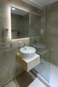 a bathroom with a sink and a glass shower at H5063 in Buenos Aires +14 photos
