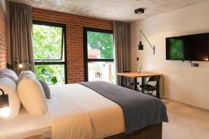 a hotel room with a bed and a table and a television at H5063 in Buenos Aires
