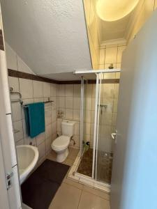 a bathroom with a toilet and a tub and a sink at Dolphin View 32 in Langstrand
