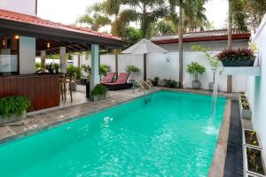 a swimming pool in the backyard of a house at Villa Barracuda in Sri Jayewardenepura Kotte
