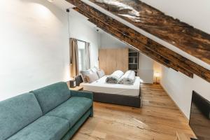 a living room with a bed and a couch at Residence Rösch in Merano