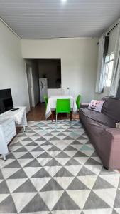 a living room with a table and a couch at Casa próxima ao Centro de Foz in Foz do Iguaçu