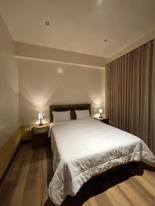 a bedroom with a large bed with two night stands at Terrazas 3400 Lodge in Oxapampa