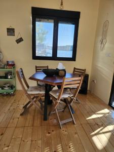 a dining room table with four chairs and a window at Splav La-familia in Umka +3 photos