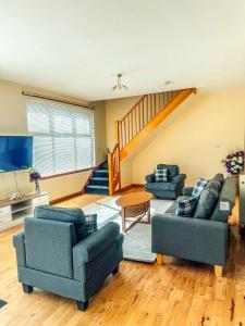 a living room with two couches and a tv at 12A-1 Stobhill Road in Arniston
