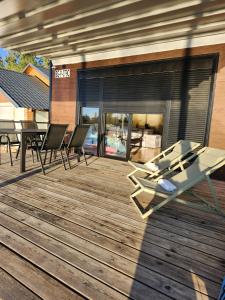 a deck with a table and chairs and a fireplace at Splav La-familia in Umka