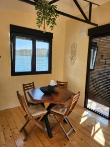 a dining room with a wooden table and chairs at Splav La-familia in Umka