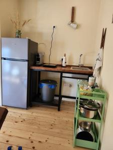 a kitchen with a refrigerator and a table with a sink at Splav La-familia in Umka