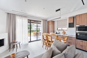 a living room with a couch and a kitchen at Képos Villas Sivota in Syvota