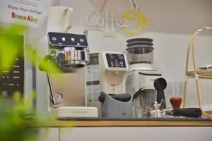 a kitchen counter with a coffee maker on a shelf at Breeze Alley Inn-English services-3mins walk to Park-12mins to Hub-Breakfast,Coffee,Laundry&Tickets in Zhangjiajie