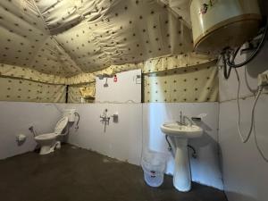 a bathroom with a sink and a toilet at Sunshine Cafe & Cottage Riverside in Shoja