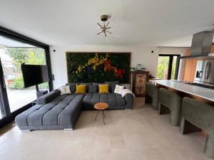 a living room with a couch and a painting on the wall at Forest Haus in Schlangenbad