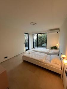 a large bedroom with a large bed and windows at Forest Haus in Schlangenbad