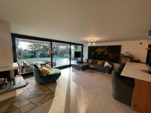 a large living room with couches and a large window at Forest Haus in Schlangenbad