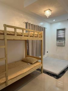 a bedroom with two bunk beds in a room at Modern Loft-Balcony-FullAC open space in Calumpit