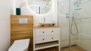 a bathroom with a sink and a shower at Apartament 19A - Villa Neptun in Gdańsk +9 photos