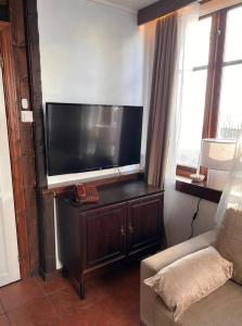 a living room with a large flat screen tv at The Old Bakery in Grimstad