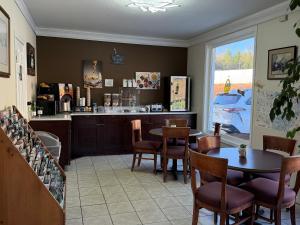 a restaurant with a table and chairs and a counter at Mountain Valley Inn in Dillard