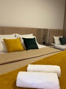 a bedroom with two beds with towels on them at Apartmani Vučinić in Cetinje