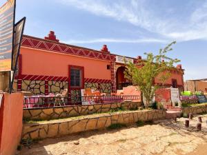 a building with a fence in front of it at Riad Bouchra in Tinerhir