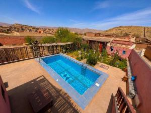 a swimming pool in the middle of a yard at Riad Bouchra in Tinerhir
