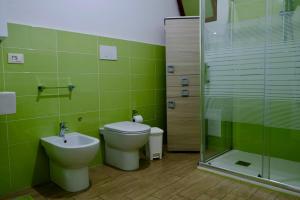 a bathroom with a toilet and a sink and a shower at Antonella's house in Casteldaccia +26 photos