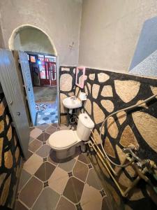 a bathroom with a toilet and a sink at Riad Bouchra in Tinerhir +40 photos