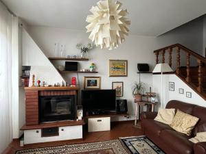 a living room with a couch and a fireplace at Casa di Azzurra in Capolona