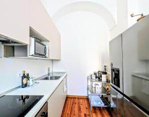a kitchen with a sink and a counter top at Appartamento Principe in Menaggio +12 photos