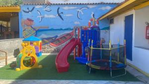 a playground in front of a mural at Pousada Thetis in Arraial do Cabo
