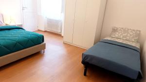 a bedroom with a bed and a chair in it at Civico 16 in Sulmona