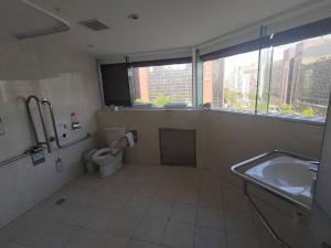 a bathroom with a sink and a toilet and a tub at Meworld Hotel - Daan in Taipei