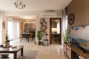a living room with a television and a dining room at MariZot Apartment in Alexandroupoli