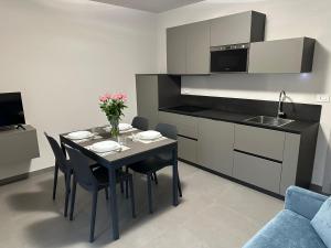 a kitchen and dining room with a table and chairs at Casa Piutin, appartamento Bucaneve in Bagnolo Piemonte