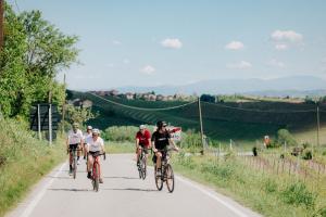 a group of people riding bikes down a road at Gabanon in Casale Monferrato