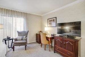 a hotel room with a television and a desk and chair at Hotel Boulderado in Boulder