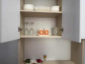 a cupboard with plates and vases on it at Nessie Homes in Nairobi