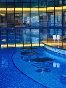 a large building with a pool in front of it at Hotel Piatra Mare in Poiana Brasov