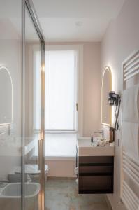 a bathroom with a shower and a sink and a tub at Ai Due Fanali in Venice