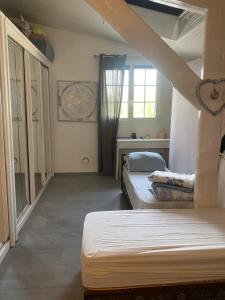 a bedroom with two beds and a window at Pavillon Val in Romainville