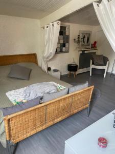 a bedroom with a large bed with a wicker frame at Pavillon Val in Romainville
