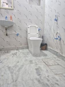 a bathroom with a toilet and a sink at Taj Street Hostel in Agra