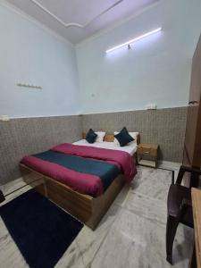 a bedroom with a large bed in a room at Taj Street Hostel in Agra