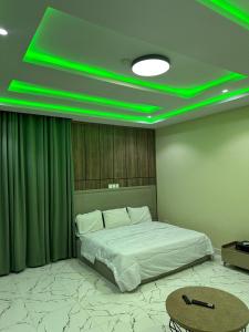 a bedroom with a bed with green lights on it at Floesth Ville in Mama