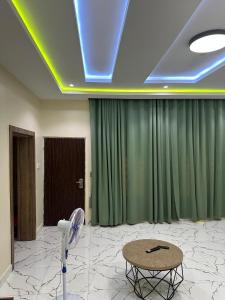 a room with a green curtain and a table at Floesth Ville in Mama