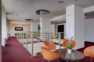 a room with chairs and a table in a building at iH Hotels Roma Z3 in Rome