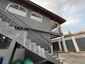 a house with a staircase in front of it at KFP Serene and Modern 2BR Flat , IBD in Ibadan