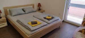 a bedroom with a large bed with yellow pillows at Apartmani Volme in Banjole