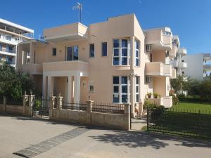 a large building with a fence in front of it at Apartments Sija in Ulcinj