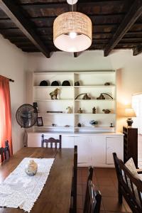 a dining room with a table and a shelf of shoes at La Cuadra - Puesto de Campo Argentino in Lobos